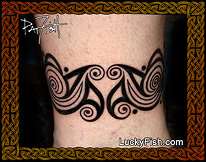 Tattoo design on a person's arm with intricate patterns, with LuckyFish.com branding