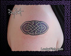 Tattoo of a Celtic knot design by Pat Fish on a person's arm with Lucky Fish branding.