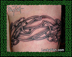 Tattoo of Celtic dog design on arm with 'Lucky Fish' branding.