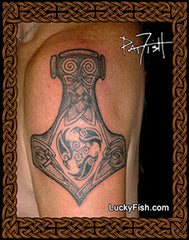 Tattoo of a Viking axe design on a person's arm with 'Lucky Fish' branding.