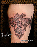 tattoo of a Celtic knot arrowhead and two wolves on a person's arm with LuckyFish branding by PatFish