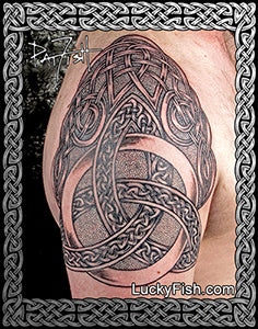 Celtic knot tattoo on a person's arm with intricate patterns.