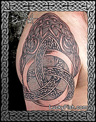 Celtic knot tattoo on a person's arm with intricate patterns.