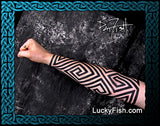 Tattooed arm with Pictish keymorphic geometric featuring LuckyFish.com branding.