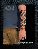 Person with a geometric tattoo of Pictish key pattern on their arm, tattooed by Pat Fish with LuckyFish.com branding.