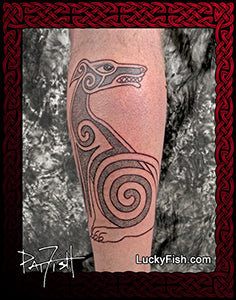 Tattoo of a stylized Irish Wolfhound Celtic dog design on a person's leg with a luckyfish.com branding
