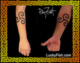 Tattoo design of a triskelion on two persons arms with 'Lucky Fish' branding.