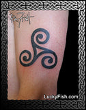 Black triskele tattoo on a person's arm with Lucky Fish branding.