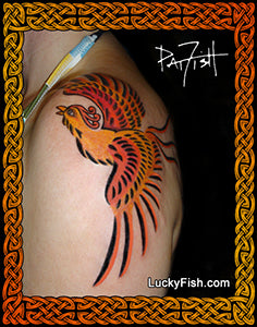 Colorful phoenix tattoo on a person's arm with 'LuckyFish.com' branding.