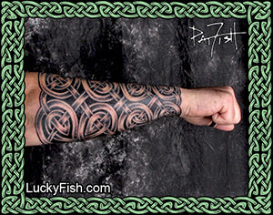 Person with intricate tattoo on arm of Celtic knotwork tattoo sleeve by Pat Fish