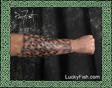 Tattooed arm with intricate Celtic knot sleeve design by Pat Fish with LuckyFish.com branding.