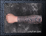 Tattooed arm with intricate Celtic patterns by Pat Fish featuring LuckyFish.com branding.