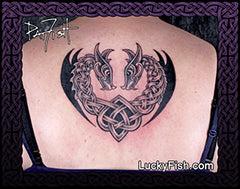Tattoo of two interlocking Celtic Norse dragons forming a heart on a person's back, with 'Lucky Fish' branding.