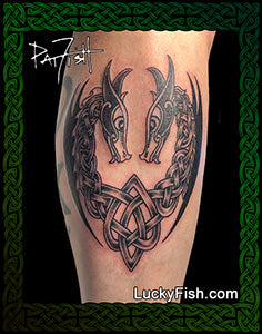 Tattoo of two interlocking dragon heads with Celtic knot patterns on a person's arm, branded 'Lucky Fish' with 'Pat Fish signature'.
