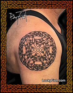 Tattoo of a Celtic knot design on a person's shoulder with 'LuckyFish.com' branding.