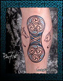 Tattoo of a double disc Pictish design on a person's leg calf with 'Lucky Fish' branding.