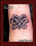 Tattoo of a heart-shaped knot on a wrist by Pat Fish of LuckyFishArt