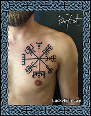 Tattoo of a Viking symbol on a person's chest with 'Lucky Fish' branding.