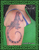 Tattoo of a zebra tailed lizard on a person's arm by Pat Fish with 'Lucky Fish' logo.
