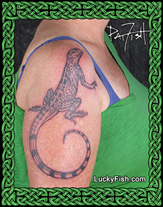Tattoo of a zebra tailed lizard on a person's arm by Pat Fish with 'Lucky Fish' logo.