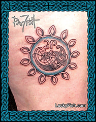 Tattoo of an Irish 2p coin, design with a circle  and bird in the center on a person's leg, featuring the brand 'Lucky Fish'.
