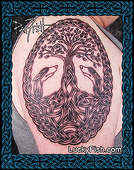 A close-up of a tattoo design on skin, featuring a tree of life with two Irish Wolfhound heads at the branches, surrounded by Celtic knotwork. The image has a decorative blue border and the text 'Lucky Fish' visible.