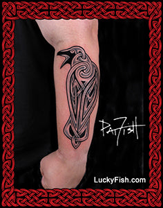 Tattoo of a Celtic raven bird design on a person's arm with 'Lucky Fish' branding.