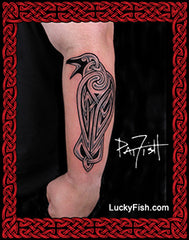 Tattoo of a Celtic raven bird design on a person's arm with 'Lucky Fish' branding.
