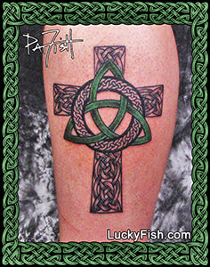 Celtic cross tattoo on a person's arm with decorative green triangle and 'Lucky Fish' branding.