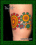 Colorful circular sprocket tattoo on a person's arm with Lucky Fish logo.