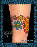 Colorful sprocket gear tattoo arm band on a person's arm with 'Lucky Fish' branding.