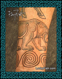 Tattoo of a Pictish bear and spiral design on skin, with Lucky Fish.com branding.