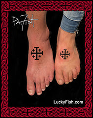 Feet with black Jerusalem cross tattoos on them featuring LuckyFish.com branding.