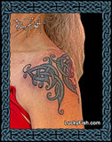 tribal butterfly tattoo on woman's shoulder