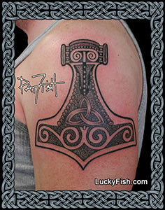 Tattoo of a Thor's hammer on a person's arm with 'Lucky Fish' branding.