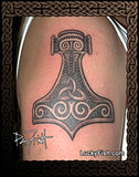 Thor's hammer tattoo on a Nordic Viking person's arm with 'Lucky Fish' branding.