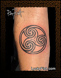 Triskele tattoo on a person's arm with 'LuckyFish.com' branding.