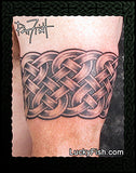 Celtic knot tattoo arm band on a person's arm with 'Lucky Fish' branding.