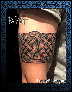 Nordic Viking knot tattoo arm band of dragon serpents on a person's arm with 'Lucky Fish' branding.
