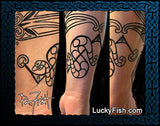 Pictish snake tattoo on a person's arm with intricate designs, including a signature LuckyFish.com branding