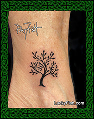 Tattoo of a tree of life design on skin with 'Lucky Fish' branding.
