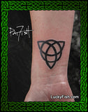 Tattoo of a black geometric Celtic triquetra triangle design on a person's arm with 'Lucky Fish' branding.