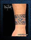 Celtic knot tattoo by Pat Fish on a person's wrist with 'Lucky Fish' branding.