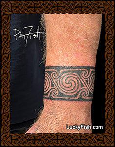 Tattoo bracelet of Pictish spiralss on a person's arm with 'Lucky Fish' branding.