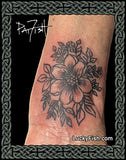 Tattoo of a floral design on a person's arm with 'Lucky Fish' branding.