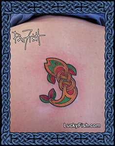 Tattoo of a colorful Celtic knot design of a fish on skin with 'Lucky Fish' branding.