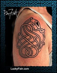 Tattoo of a Norse Nordic Viking knot dragon design on a person's shoulder with 'LuckyFish.com' branding.