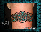 Celtic knot tattoo on a person's arm with 'LuckyFish.com' branding.