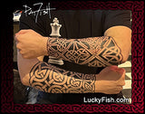 Person wearing two sleeves with intricate Celtic tribal designs, with 'Lucky Fish' branding.