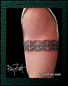 Tattoo of a Celtic knot design armband on a person's arm with 'Lucky Fish' branding.